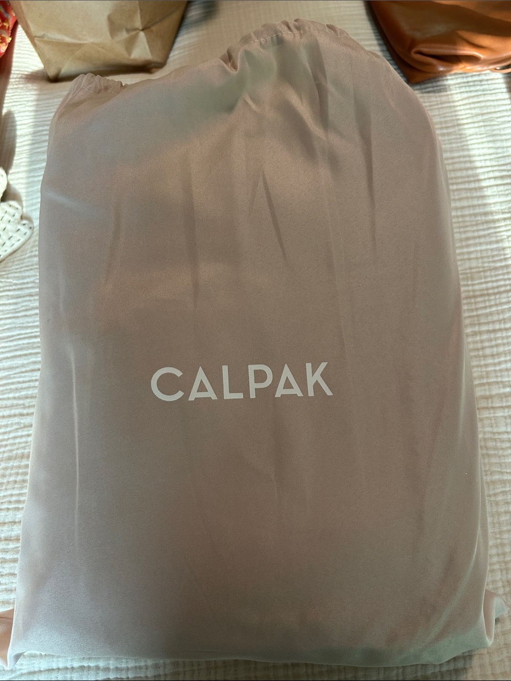 Calpak in caramel with Blush Pink Logo Dust Cover